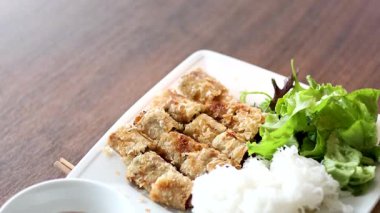 Bun Cha dish with herbs and dipping sauce