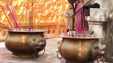 Incense burners with vibrant sticks in Hong Kong temple