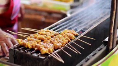 Skewers being grilled at a floating market