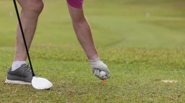 Golfer executing a tee shot on the course.