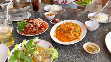 Group enjoying seafood meal in Chonburi, Thailand