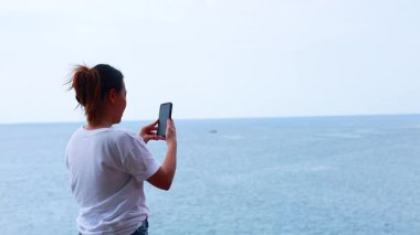 Kadın, okyanus zeminiyle selfie çekiyor.