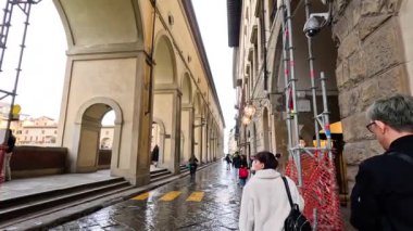 İnsanlar Floransa, İtalya 'da kemerlerin altında yürüyor