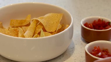 Eller kasedeki cipslere salsa servisi yapıyor.