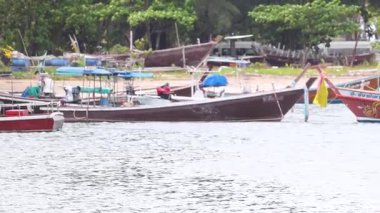 Tayland, Phuket 'teki Sarasin Köprüsü' nden geçen bir balıkçı teknesi, gün ışığında sakin kıyı manzarası sergiliyor.