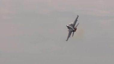 military plane flying in cloudy sky  