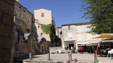 view of a street with a small stone town, a medieval town, in the background