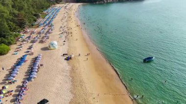 aerila view of tourists relaxing on beautiful beach at sea 