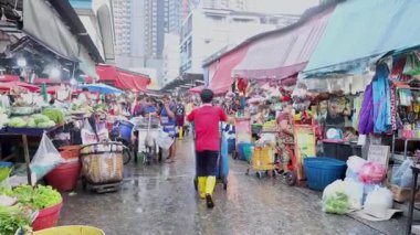 Vibrant street market activity during a rainy day