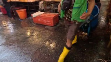 Islak pazarda çalışan işçiler taşınıp temizleniyor.