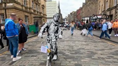 Performer on bike entertains festival crowd
