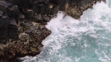Dynamic ocean waves hitting against a rugged coastline