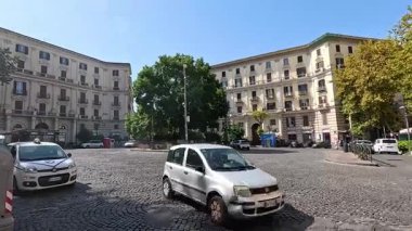 Vehicles and pedestrians in a Naples street