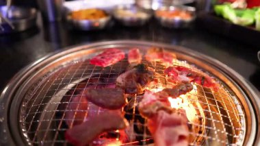 Grilling pork and beef on a barbecue