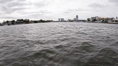 City skyline and waterfront under cloudy skies