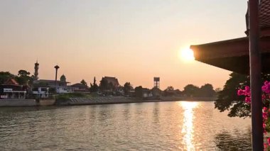 Güneş sakin bir nehir manzarasının ardında batıyor