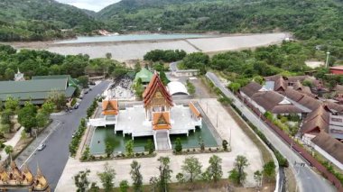 İnsansız hava aracı görüntülerinde Phuket, Tayland 'da yemyeşil ve sakin bir nehirle çevrili huzurlu bir Budist tapınağı görülüyor.
