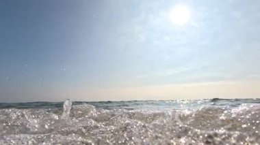 Dalgalar kumlu sahile ağır çekimde çarpıyor