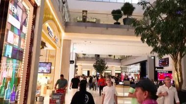 İnsanlar Dubai 'de alışveriş ve yürüyüş yapıyor.