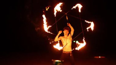 Gece Karon Sahili, Phuket 'te büyüleyici bir ateş dansı gösterisi. Alevli aksesuarların ustalıkla manipüle edilmesi.