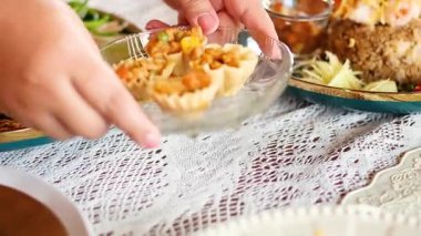 Hands serving delicious Thai savory tartlets