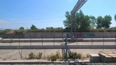 Train passing through Turin's urban railway landscape