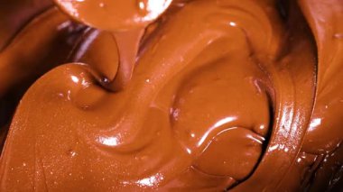 Rich chocolate being mixed and swirled smoothly