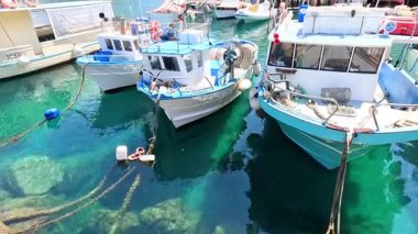 Boats docked in clear turquoise water