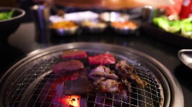 Grilling meats on a barbecue at a restaurant