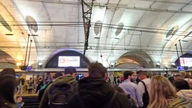 People waiting at a busy metro station