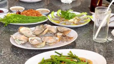 Delicious oysters and greens on a table