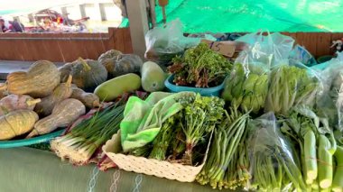 A colorful array of fresh vegetables displayed at a floating market in Bangkok, showcasing local produce under natural lighting