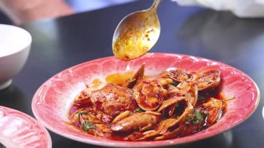 Preparing spicy stir-fried clams dish in Phuket, Thailand