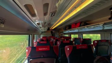 Passengers enjoy views from a moving train