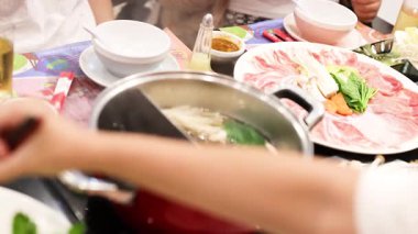 Cooking and sharing hotpot meal in Bangkok