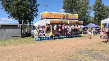 People enjoying games at an outdoor fair