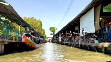 Colorful boats navigate bustling canal market