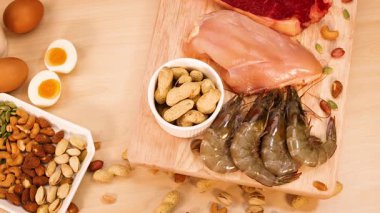 Assorted meats, nuts, and eggs on a table