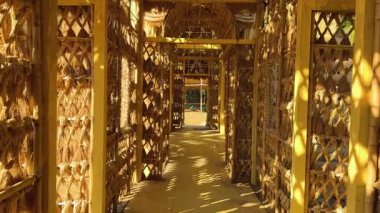Exploring a rice straw house in sunlight
