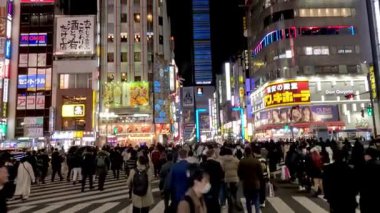 Crowds crossing at a vibrant urban crosswalk