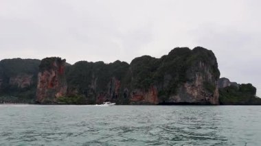 Boat travels past scenic Krabi rock formations