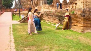Women in traditional attire perform a dance