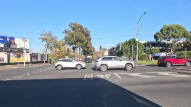 Melbourne şehir trafiğinde arabalar ve tramvaylar