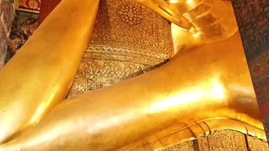 Golden Buddha statue in serene temple setting