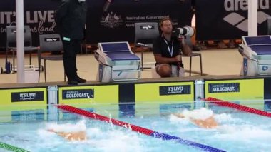 Yüzücüler hızlı bir yarışta yarışıyorlar.