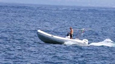 Sakin denizde sürat teknesi süren adam