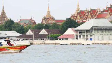 Longboat ikonik Bangkok Tapınağı manzarasının önünden geçiyor