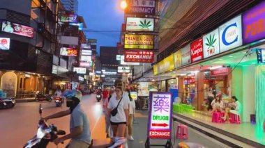 Dükkanlar ve turistlerin olduğu hareketli bir sokak sahnesi