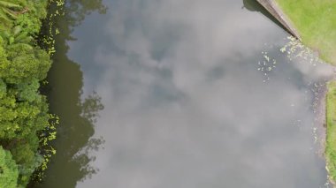 İnsansız hava aracı Gold Coast, Avustralya 'daki huzurlu nehir ve barajı görüntülüyor. Bereketli yeşillik ve sakin sular sakin bir manzara yaratır.