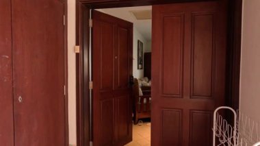 Tahta kapı tekrar tekrar açılıyor ve kapanıyor.